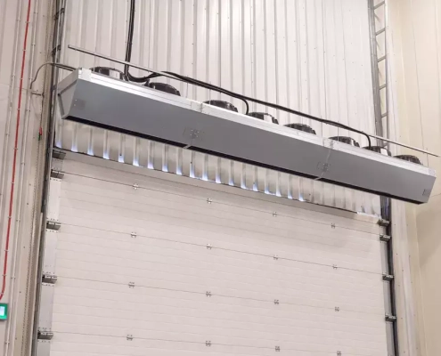 Industrial air curtains or air doors heated or ambient air for distribution centres and warehousing using an energy efficient high airflow fan to protect the indoor air from the exterior environment Flexiheat UK