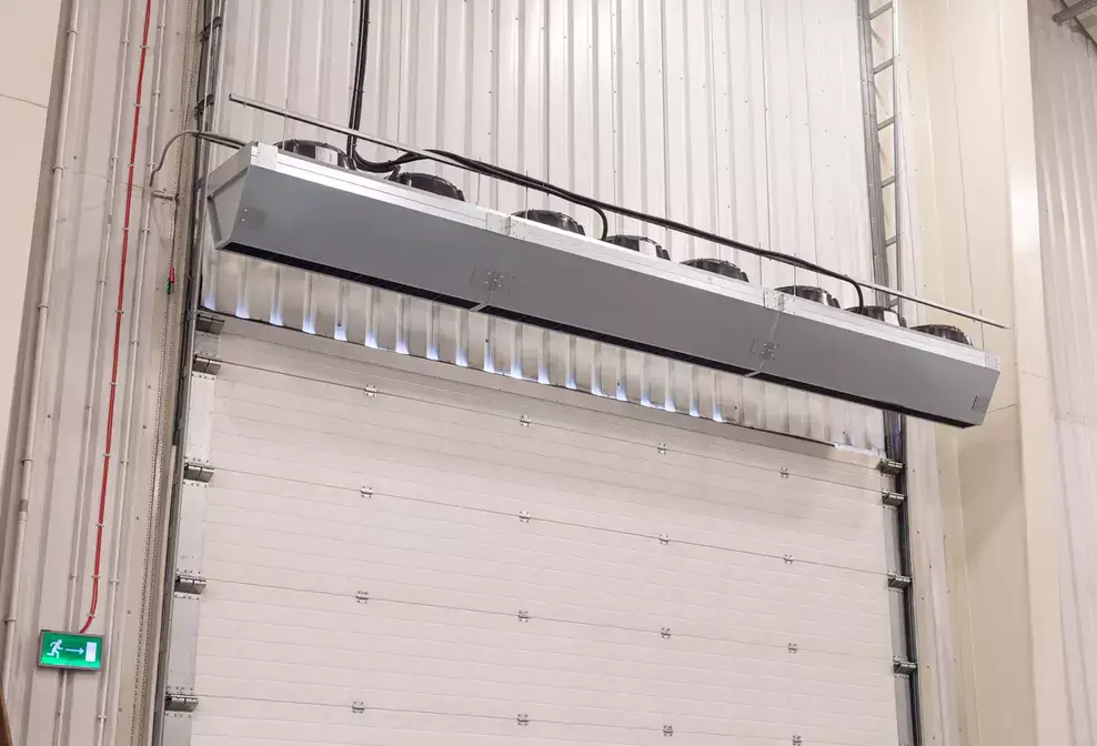 Industrial air curtains or air doors heated or ambient air for distribution centres and warehousing using an energy efficient high airflow fan to protect the indoor air from the exterior environment Flexiheat UK